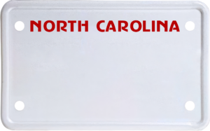 USA license plate North Carolina red text
